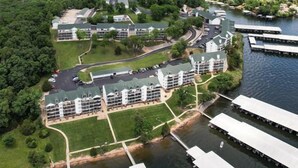 An aerial view of a hotel complex with multiple buildings, a marina, and surrounding greenery. - Amazing Views from Balcony, Loft & Gated Pool (Kaiser)