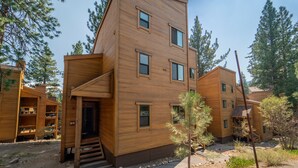 A modern wooden building with multiple windows and a staircase leading to the entrance. - Cozy mountain hideaway for hikers, skiers and chefs! (Truckee)