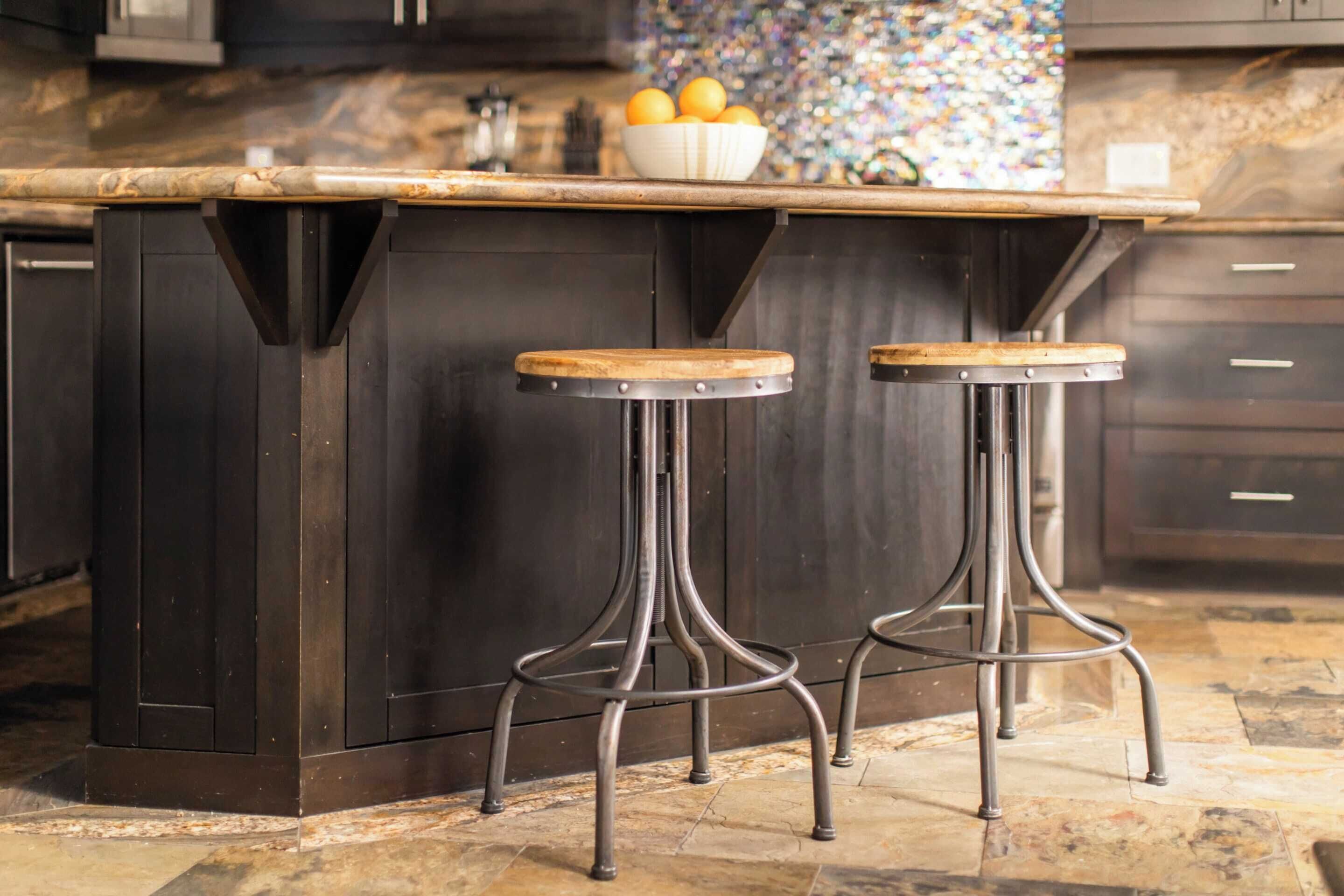 A dark wooden bar stool with a metal base and a wooden seat.