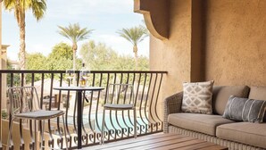 A balcony with a wicker sofa, two chairs, a small table, and a bottle of wine. - Eucalyptus by Avantstay Stunning Scottsdale Home w/ Communal Pool & Hot Tub (Scottsdale)