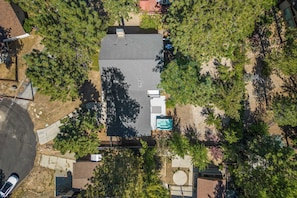 Relax in a spacious backyard with a swimming pool surrounded by lush greenery and mature trees.