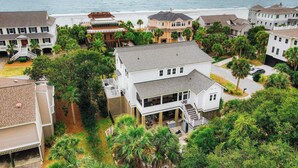 A coastal residential area with multiple houses, some with balconies overlooking the beach. - 1blck to Beach, Pool, Outdoor Kitchen, Game Room Pelican by Avantstay (Isle of Palms)