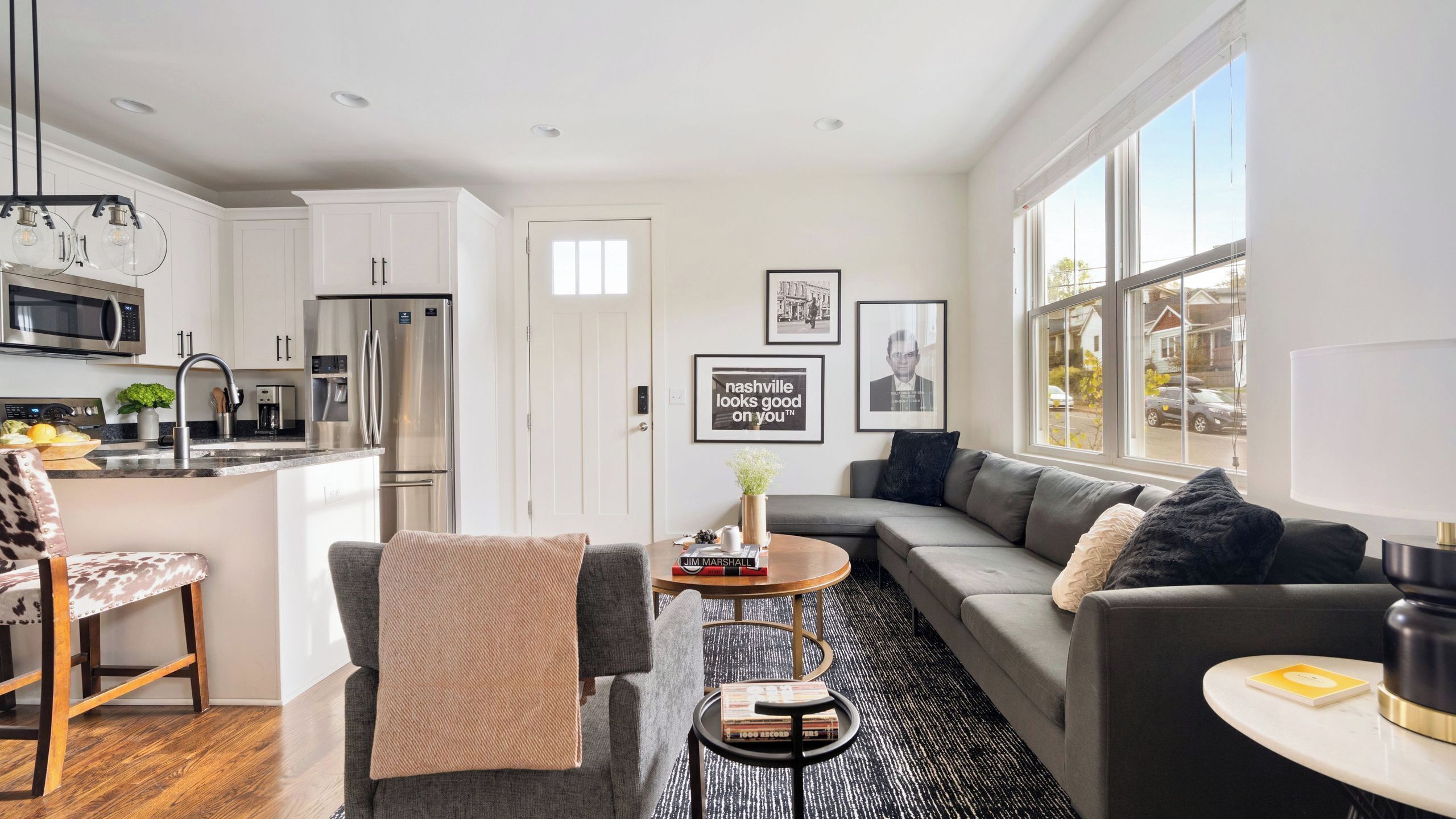 A modern living space with a kitchen, dining area, and seating area.