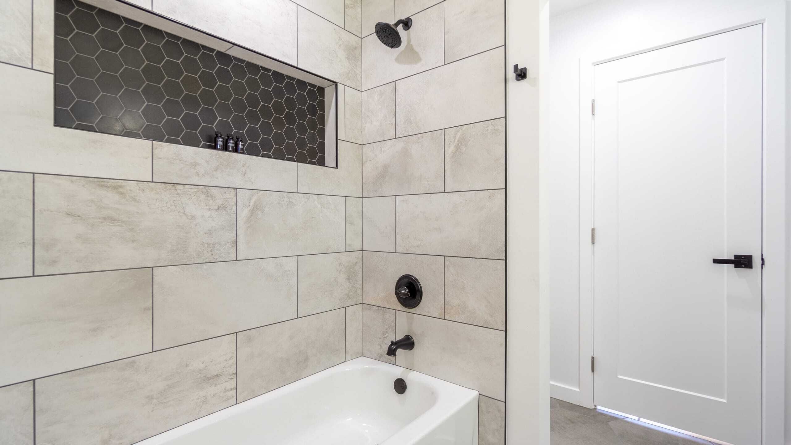 A bathroom with a bathtub, a shower, and a toilet.