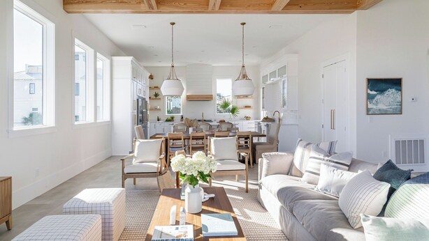 A spacious living area with a sofa, coffee table, and dining table. - Rendezvous by Avantstay Modern Haven w/ Game Room, Roof Top, Pool & Close to Beach! (Miramar Beach)