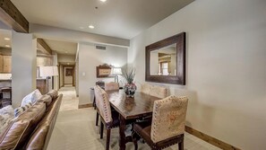 A dining area with a wooden table, upholstered chairs, a sofa, and a large mirror on the wall. - Mont Cervin #24 by Avantstay Luxury Ski in Ski out Home in Park City! (Park City)