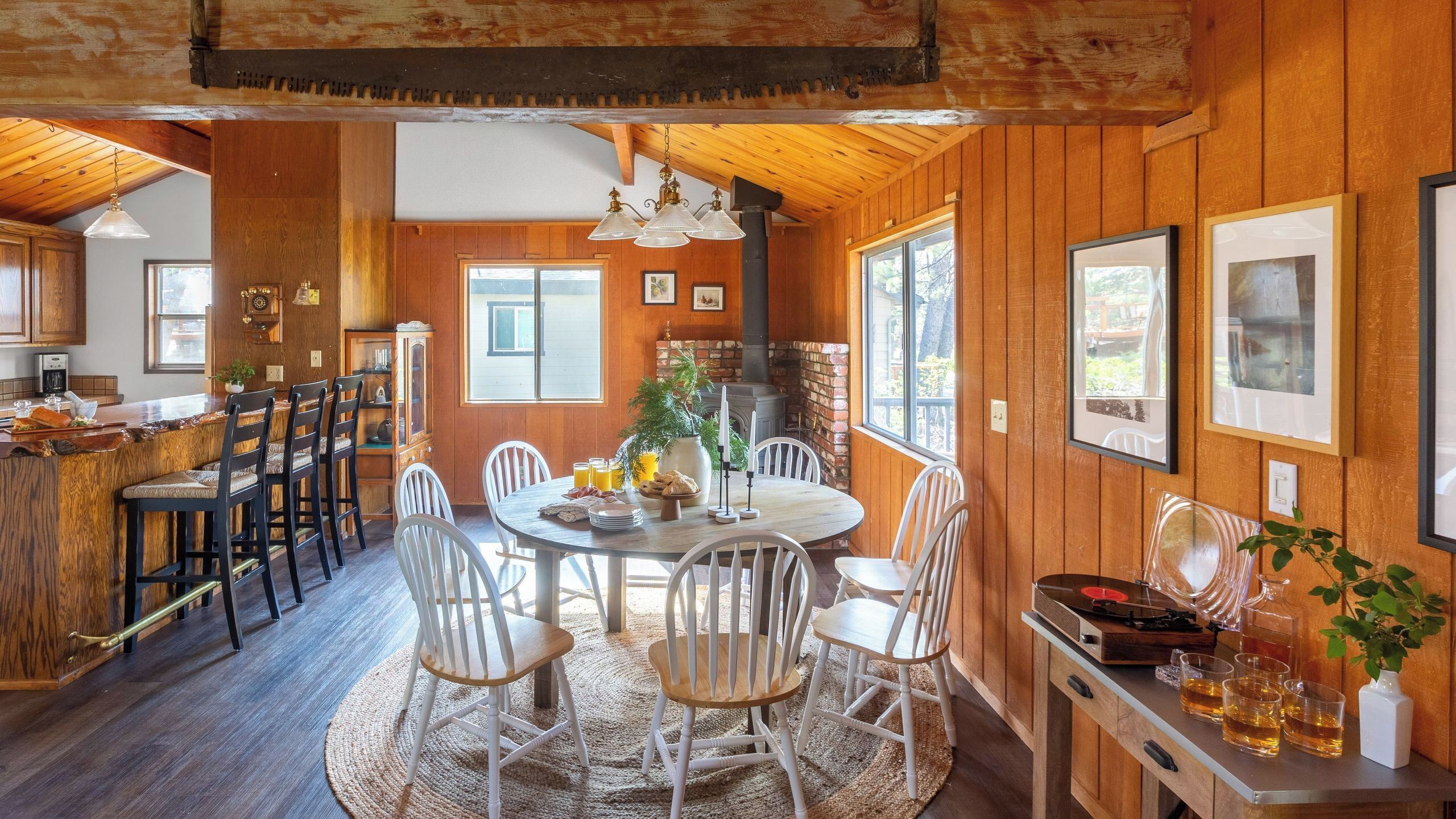 A wooden interior with a dining area, kitchen, and bar.