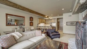 A living room with a sofa, armchair, coffee table, and a fireplace. - Mont Cervin by Avantstay Condo w/ Hot Tub + Jetted Tub + Fireplace Ski-in/ski-out (Park City)