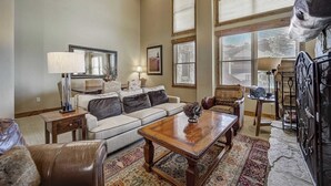 A living room with a sofa, coffee table, and a fireplace. - Mont Cervin #33 by Avantstay Luxury Ski in Ski out Home in Park City! (Park City)