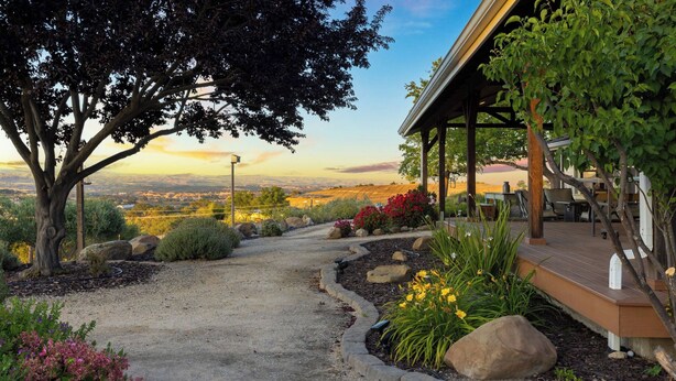 A covered outdoor area with a gravel path, surrounded by rocks and plants, leading to a scenic view. - 4.5 Acre Secluded Ranch w/ Panoramic Views Fire Pit Olive Ranch by Avantstay (Paso Robles)