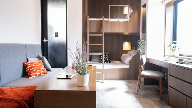 A modern room with a sofa, a desk, a ladder, and a window. - ORI Rokkaku (Kyoto)