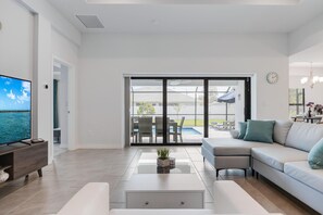 A modern living room with a sofa, coffee table, and TV.