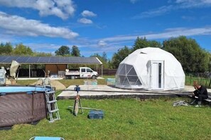 A large white dome structure with a door, a covered outdoor area with solar panels, and a swimming pool. - 2brCabin-Fireplace-HotTub-Sauna-SkiResort (Brasov Bran Predelut)