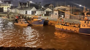 A harbor at night with boats docked, a crane, and buildings in the background. - Immaculate 2-Bed Lodge in Monreith (Newton Stewart)