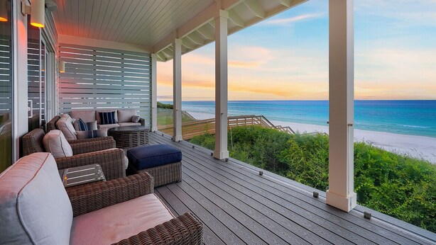 A covered outdoor seating area with wicker furniture and a view of the beach. - A Gulf Dream - Gulf Front with Private Pool and Carriage House (Santa Rosa Beach)