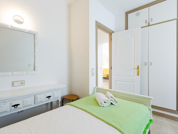A bedroom with a bed, a dresser, a mirror, and a wardrobe. - Las Floritas 23 Terrace and Swimming Pool (Playa de las Américas)