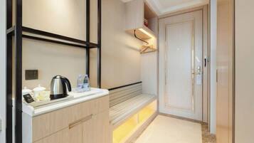 A modern kitchen with a built-in bench, a kettle, and a coffee maker.