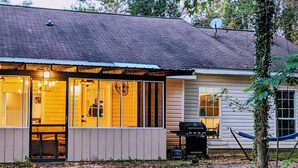A house with a covered porch, a grill, and a hammock. - Auburn Tiger Alumni Retreat on 20 acres (Salem)