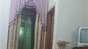 A room with a bed, a television on a stand, and a window with curtains. - Hotel Shining Star (Mekhtar)