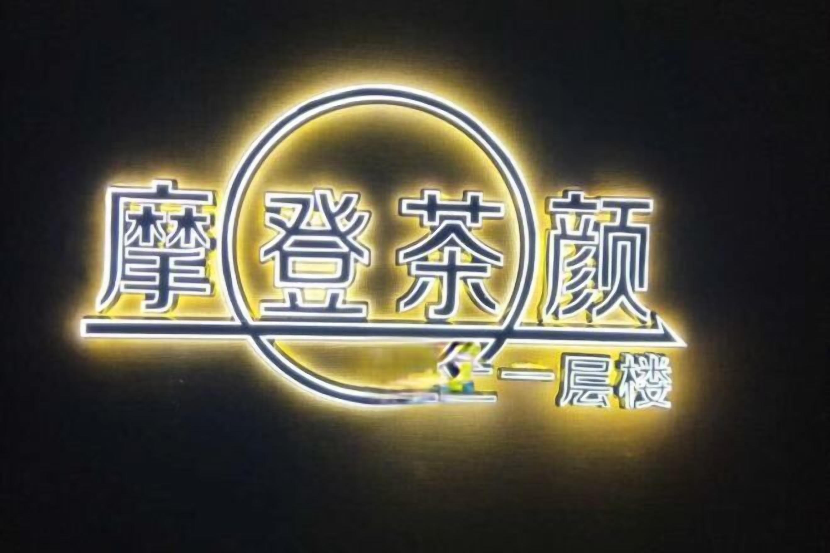 A neon sign with Chinese characters, likely representing a hotel or establishment.