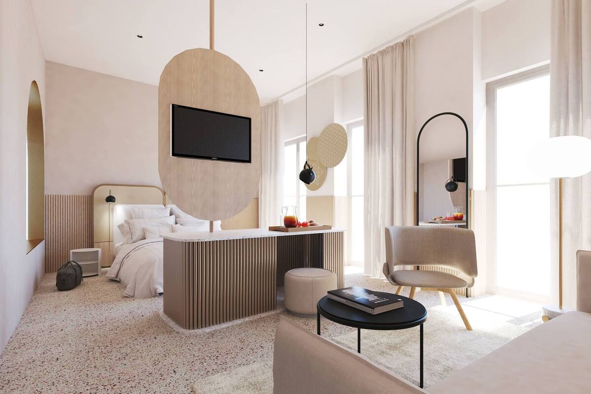 Una habitación de hotel moderna con un televisor grande, un área de comedor, un sofá confortable y una silla elegante.