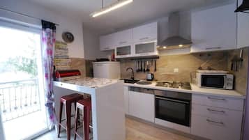 Villa | Private kitchen | Fridge, microwave, oven, stovetop