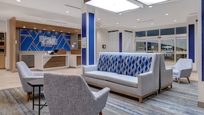 A modern lobby with a reception desk, seating area, and large windows. - Holiday Inn Express & Suites Ontario - Chino Hills by IHG (Chino Hills)