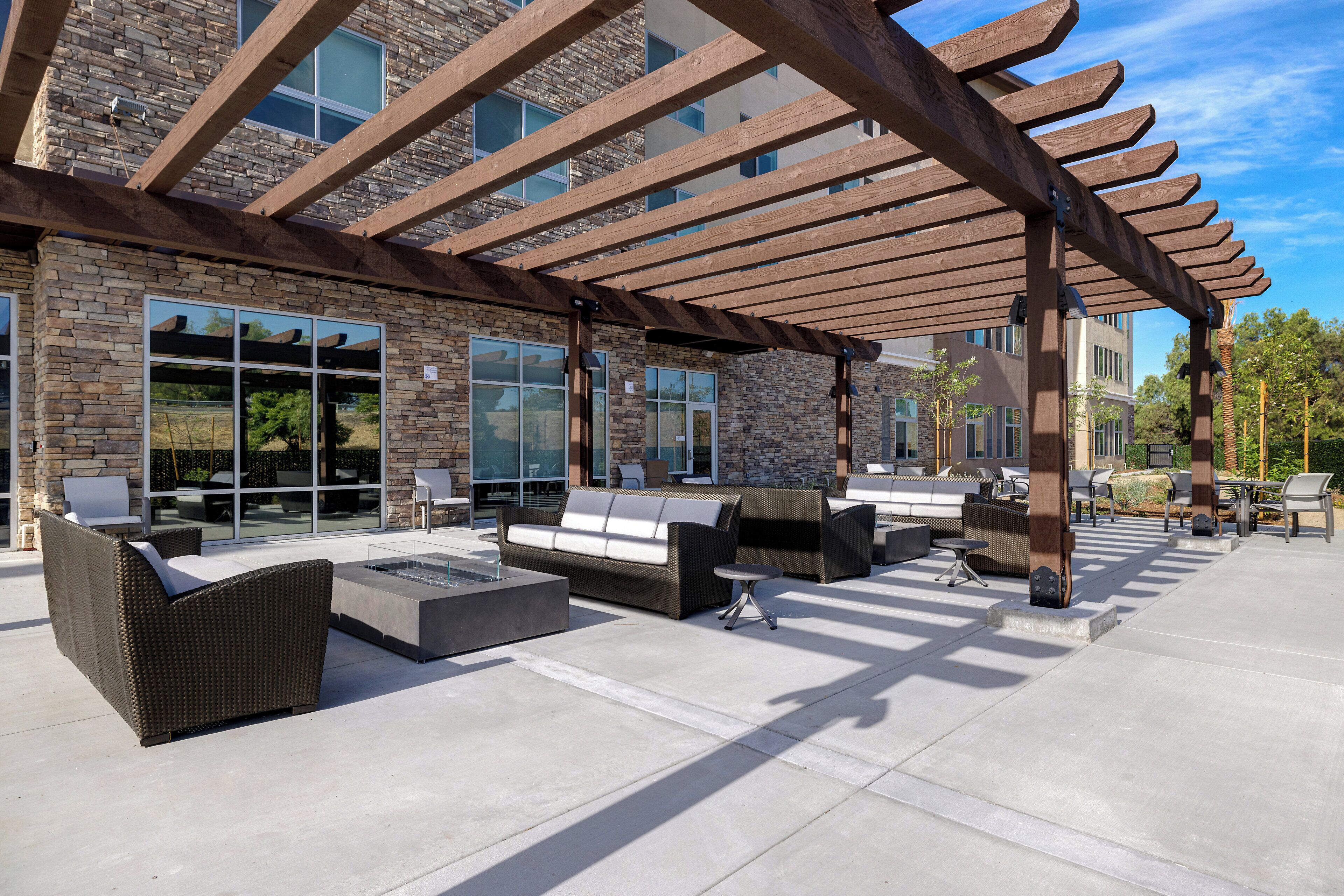 An outdoor patio area with seating and a fire feature.