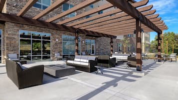 An outdoor patio area with seating and a fire feature.