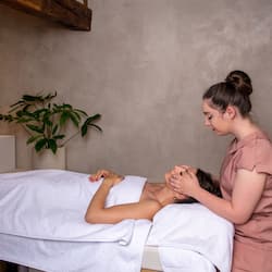 Experience a serene spa session on a comfortable massage table, surrounded by a peaceful atmosphere.