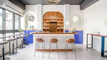 Check-in at our self-service bar, featuring cushioned stools and a sleek countertop.