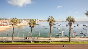 A coastal cityscape with a marina, palm trees, and a promenade. - Apartment 'Cascais Bay Terrace IV' with Sea View & Wi-Fi (Cascais)