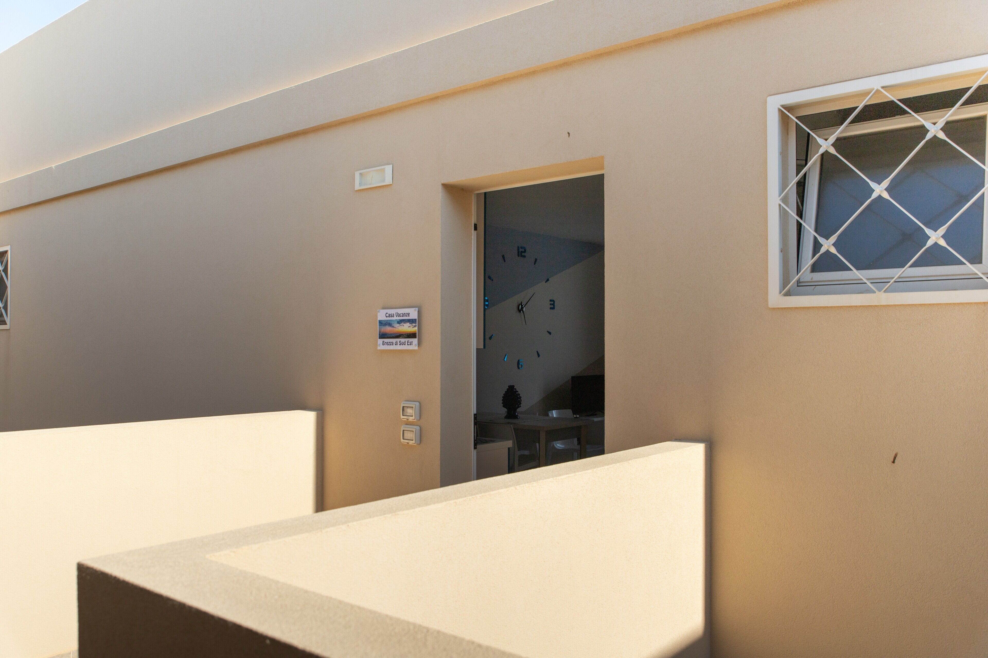 A hotel room with a bed, a window, and a door leading to a bathroom.