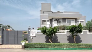 A modern two-story building with a grey facade, a balcony, and a sign indicating a restaurant. - Enkay Residency Sector 15 (Gurugram)