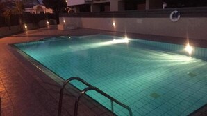 A rectangular swimming pool with a tiled floor and a metal ladder on one side. - 2br-7 Guests-free Parking-pool-aircon (Paralimni)