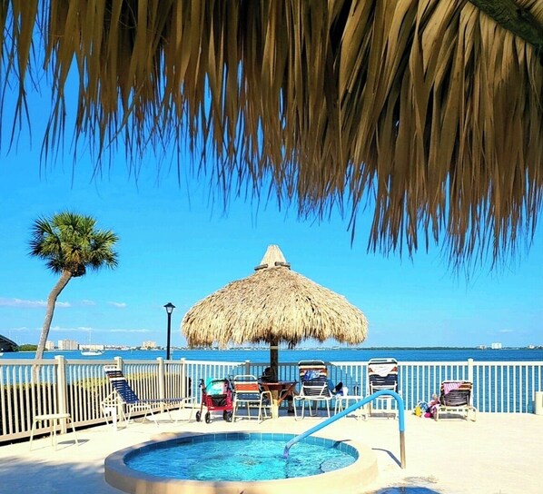 Relax by the ocean at this beachfront pool, surrounded by lounge chairs and a small pool with a water circulation system.