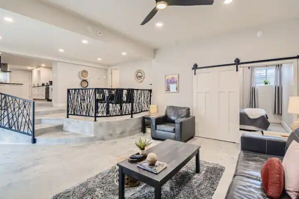 Relax in this stylish living area with a sofa, armchair, and coffee table, perfect for unwinding.
