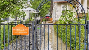 A gated entrance to a property named 'Madison House' at 2130 N Nevada Avenue, with a clear pathway leading to the house.