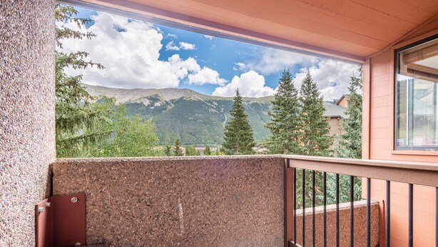 A balcony with a view of mountains and trees. - Perfect Ski-in/out condo Center Village, Free Parking, WiFi, Amazing views (Copper Mountain)