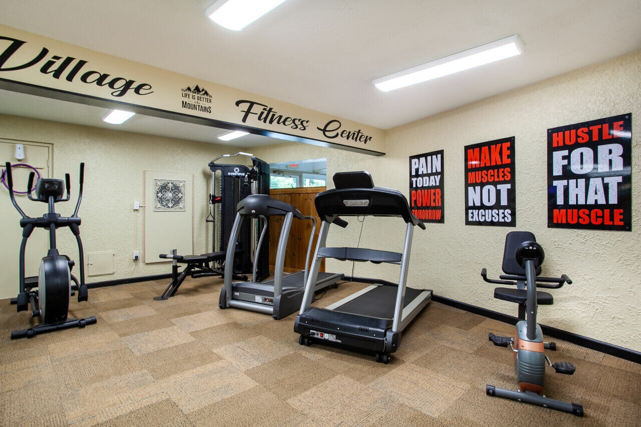 A fitness center with treadmills, ellipticals, and weight machines.