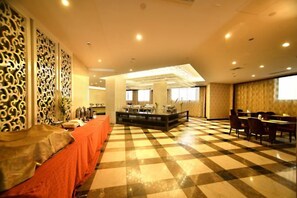 A hotel lobby with a checkered floor, a reception desk, and seating areas. - Xiangshui Guest Hotel (Xiangshui)