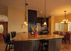 Enjoy meals and socialize around the central island with bar stools and dining chairs.