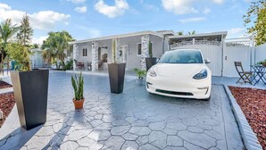 A modern building with a white car parked in front.