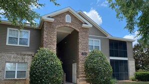 A two-story building with a brick entrance, a large window on the second floor, and a number '800' on the side. - 2 BR/ 2BA Condo1 King /2 Full beds Sleeps 6 close to OWA & Foley Tourism Complex (Foley)