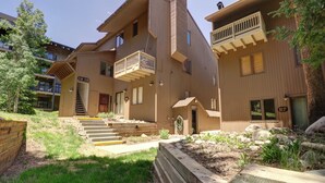 A multi-story building with a wooden exterior, a balcony on the second floor, and a staircase leading to the entrance. - Rare Gem, Spacious Condo, Outstanding Location A6 (Copper Mountain)