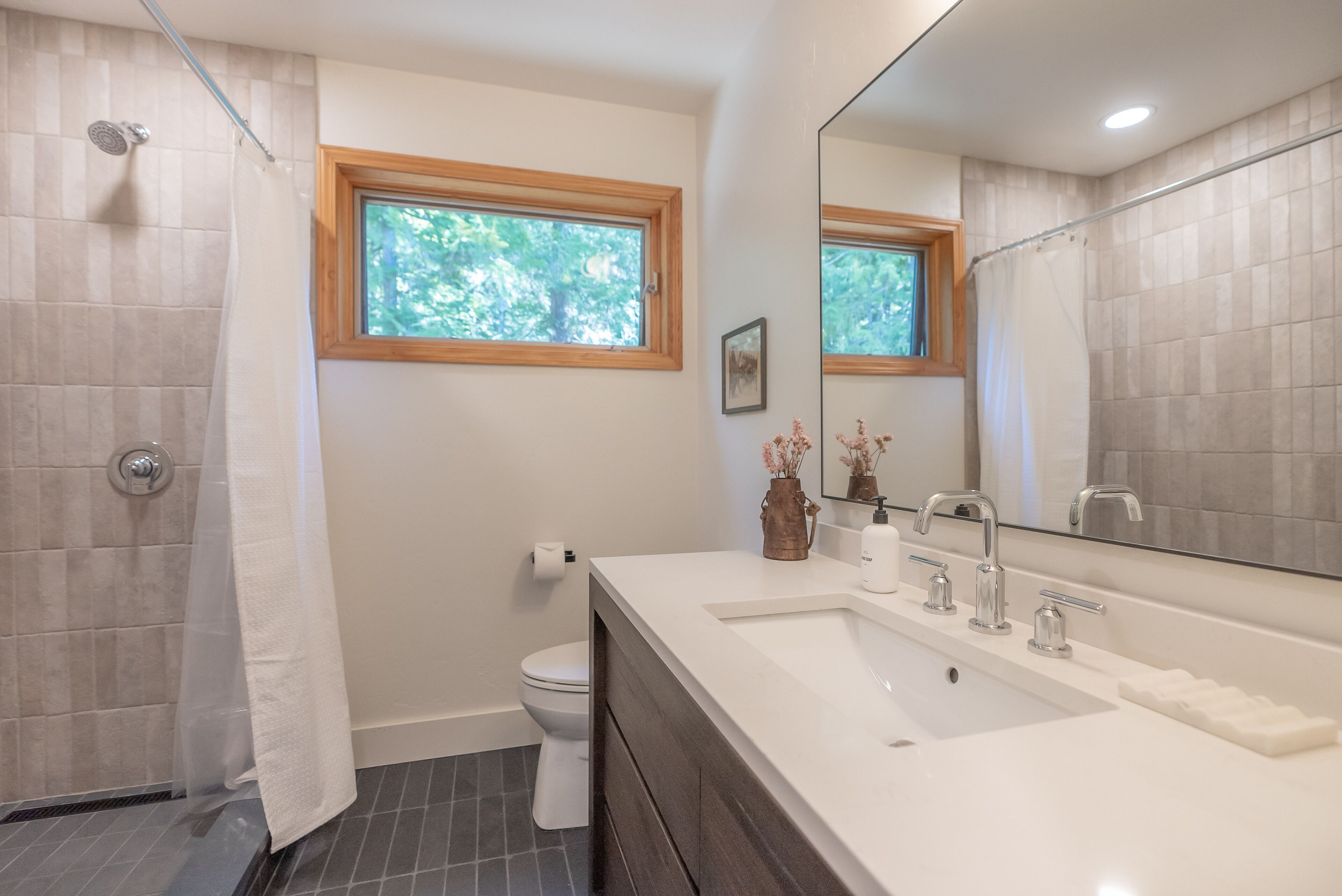 Modern mountain design includes Restoration Hardware vanity and quartz counters