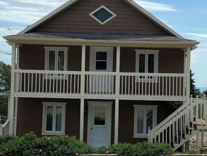 Welcome to this charming two-story house with a welcoming front porch and a small balcony.