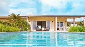A pool area with a covered seating area, a table, and chairs. - Sombre 14-e (Santa Cruz)