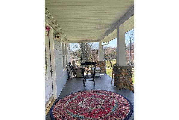 Step out onto the covered porch and enjoy the serene atmosphere.