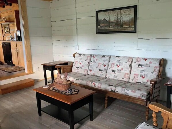 A cozy living room with a wooden sofa, a small wooden table, and a basket.